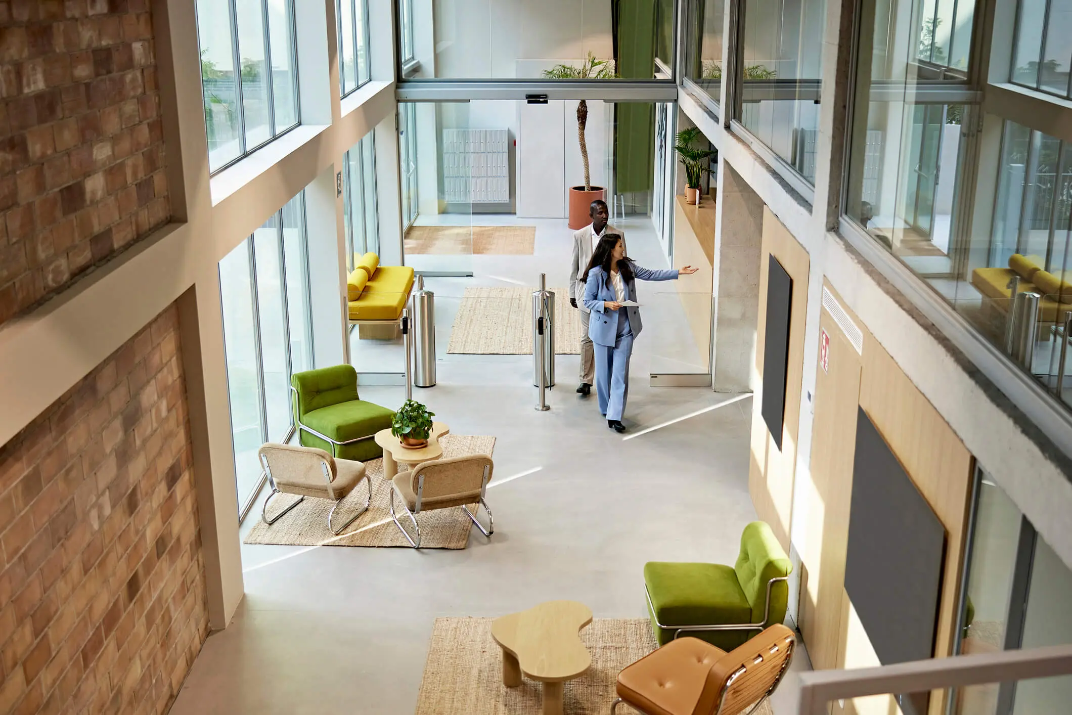 Woman walking through bright office lobby