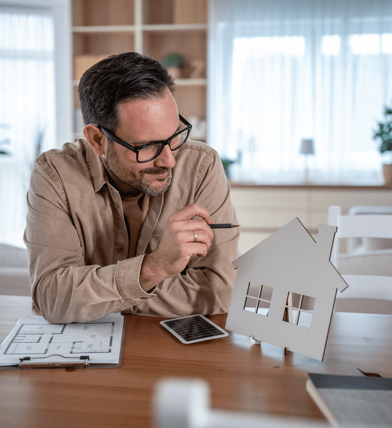 Architect examining house model on desk