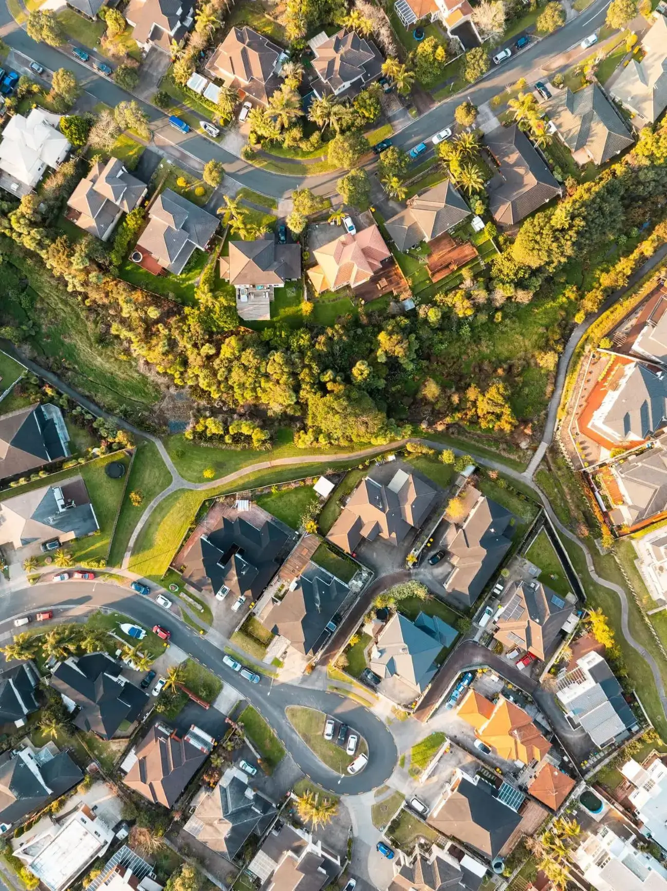 Curving cul-de-sac with houses and greenbelt