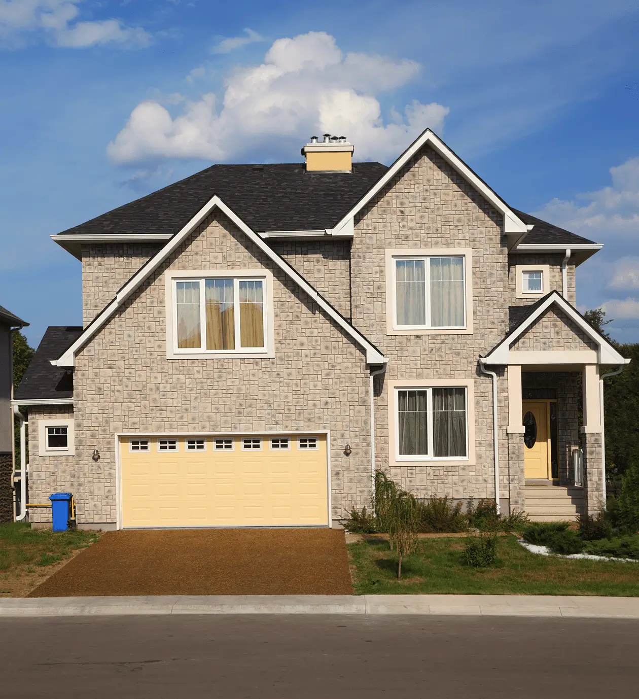 Stone-faced home with yellow garage door